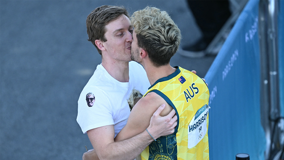 Australia's Campbell Harrison (R) kisses his boyfriend after competing in the men's sport climbing boulder semi final during the Paris 2024 Olympic Games at Le Bourget Sport Climbing Venue in Le Bourget on August 5, 2024.