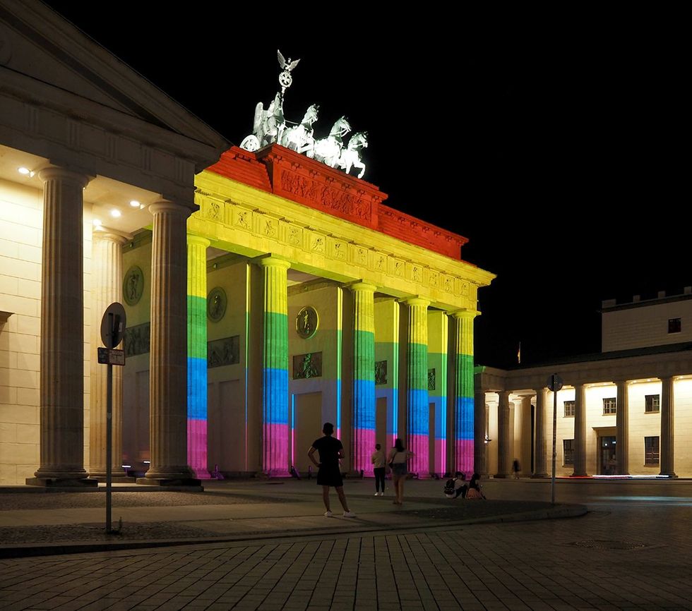 berlin germany Brandenburg Gate Monument that is lit in the colors of the Rainbow Flag