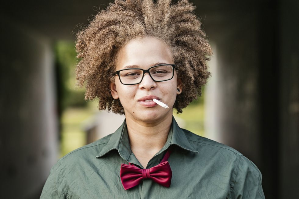 Butch lesbian smoking a cigarette