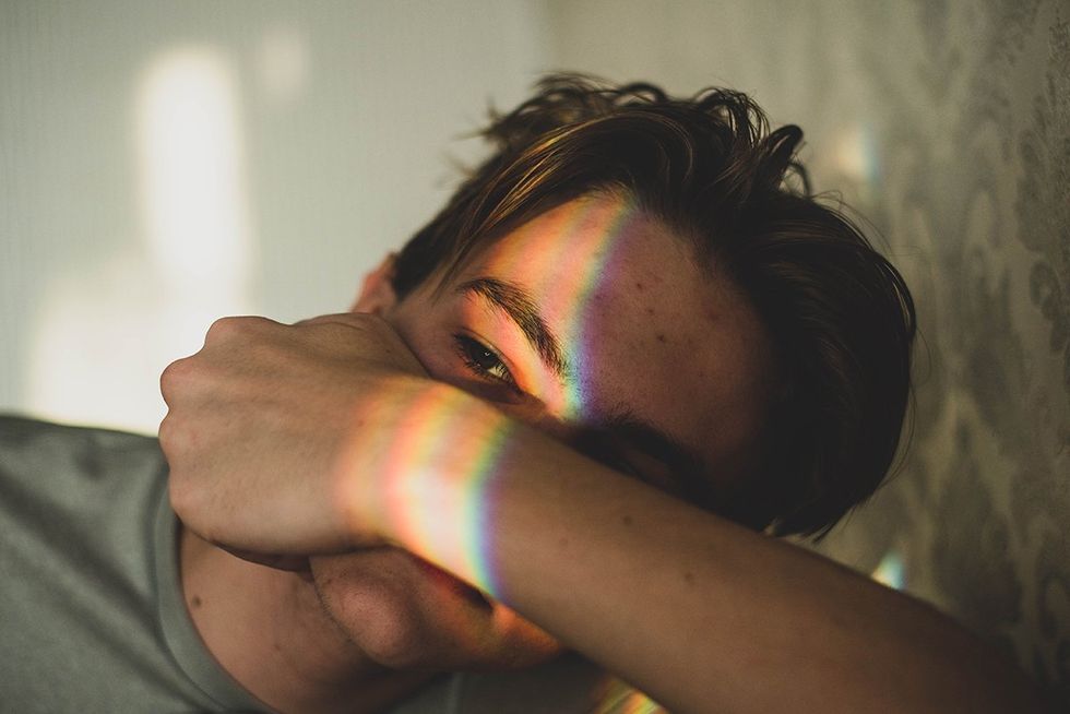 gay man anixious with rainbow on his face