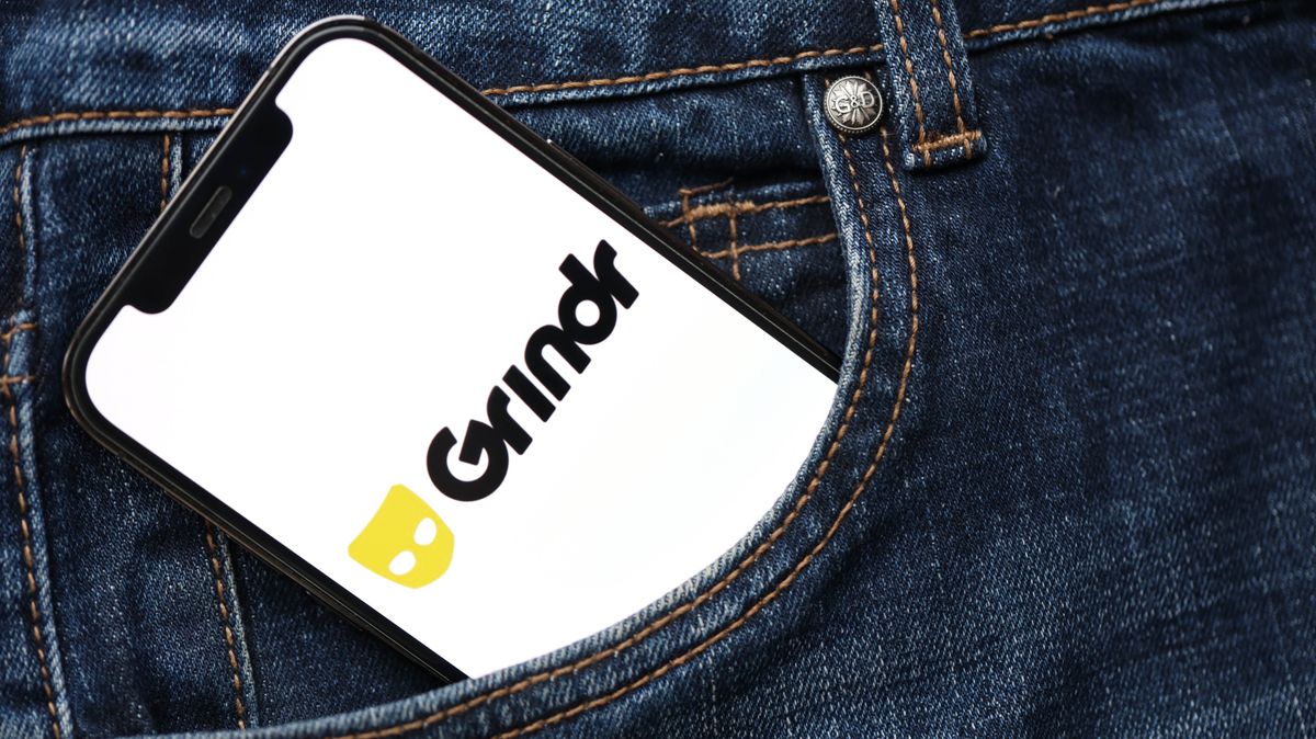 Grindr on a cell phone in the pocket of a pair of jeans