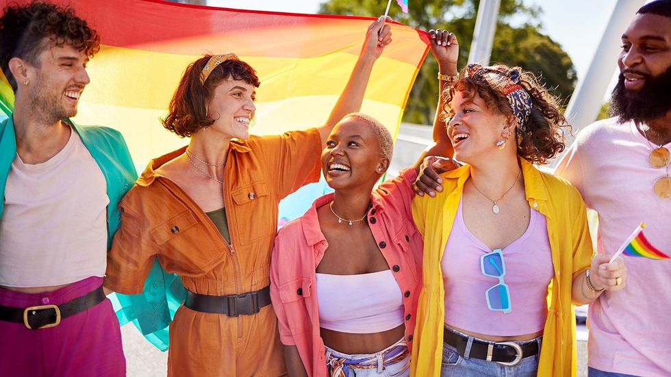 happy queer friends rainbow flags support LGBTQIA celebration