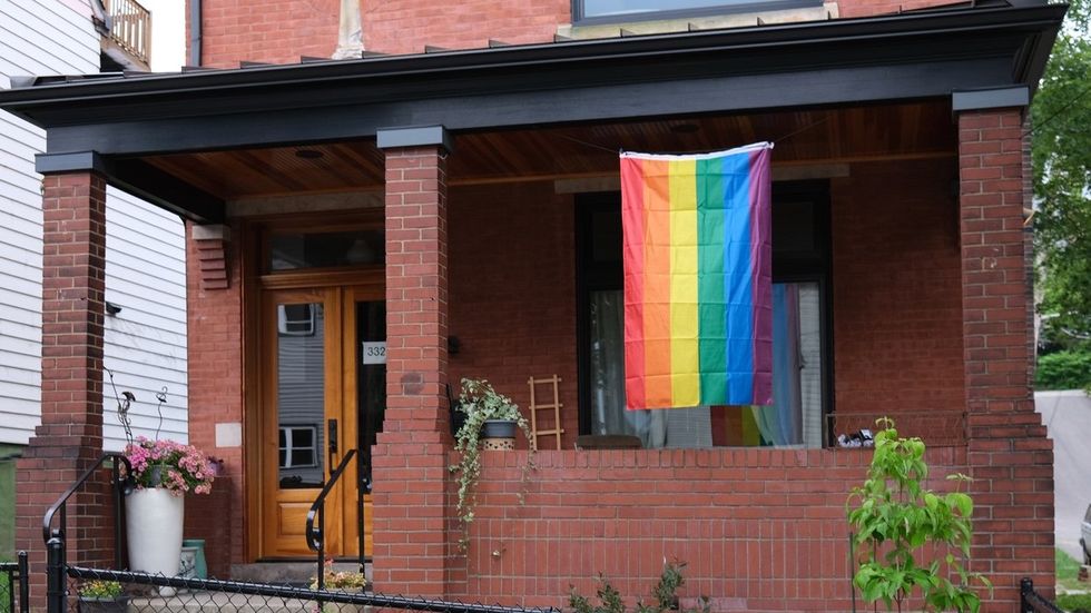 home with a rainbow flag out front