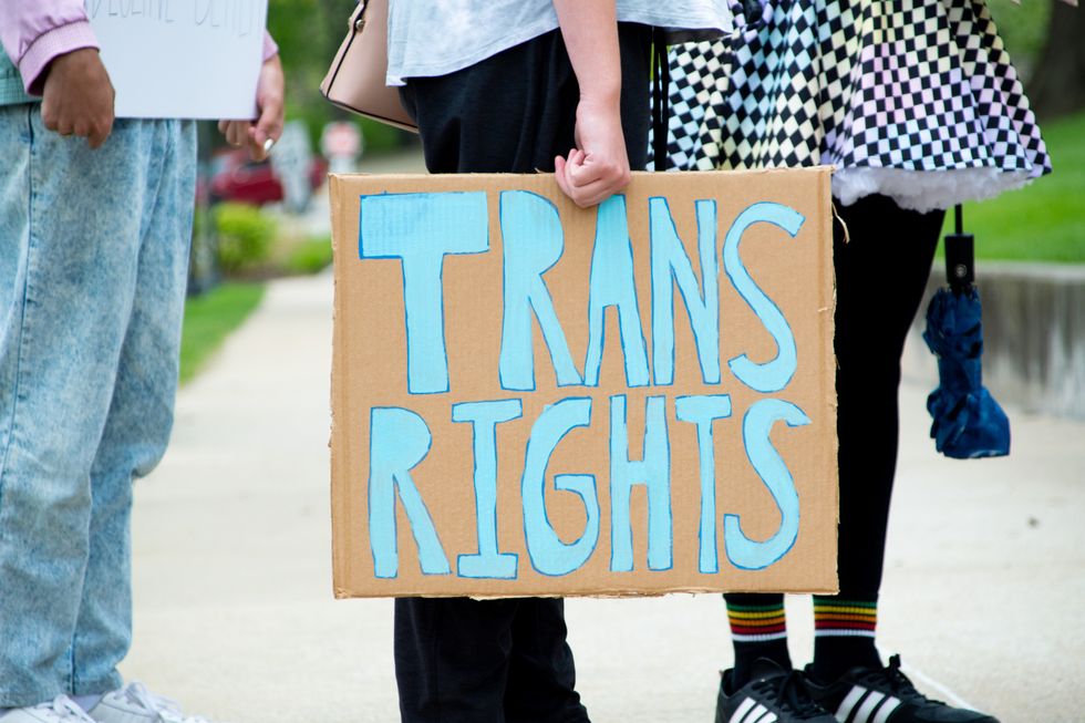 JEFFERSON CITY, MO. - April 17, 2021: Unidentifiable rally attendee holds a sign reading, "Trans Rights" at a protest demanding equality for trans humans and to denounce anti-trans legislation.