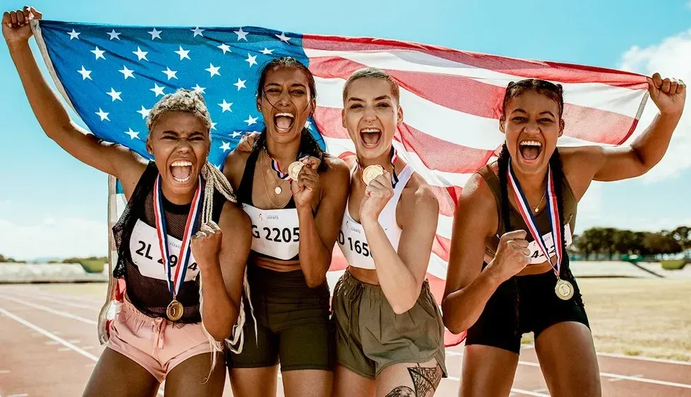 queer transgender nonbinary track athletes celebrating medals american flag