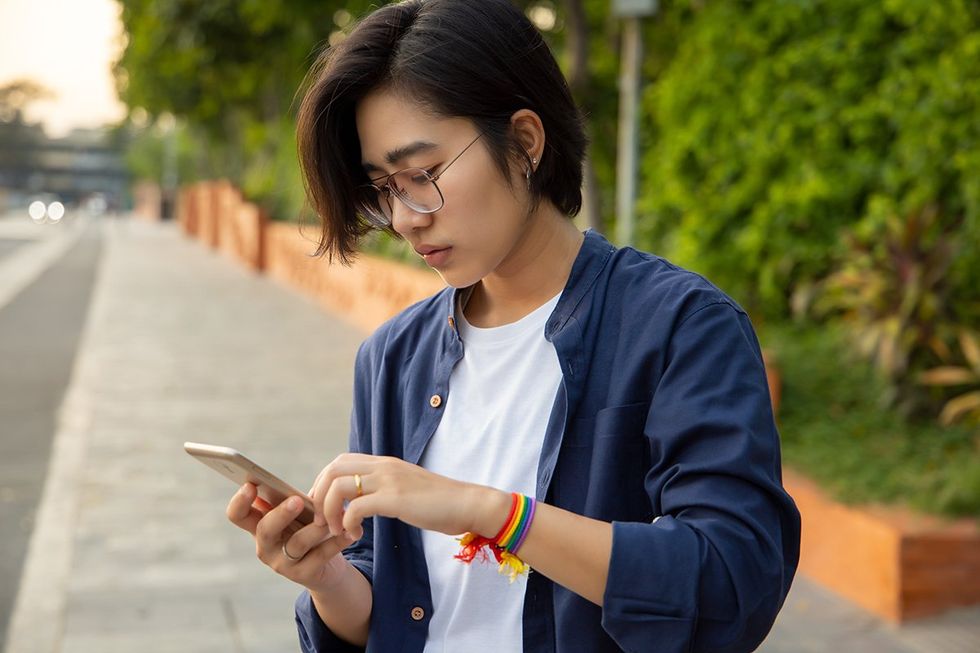 queer woman looking at phone