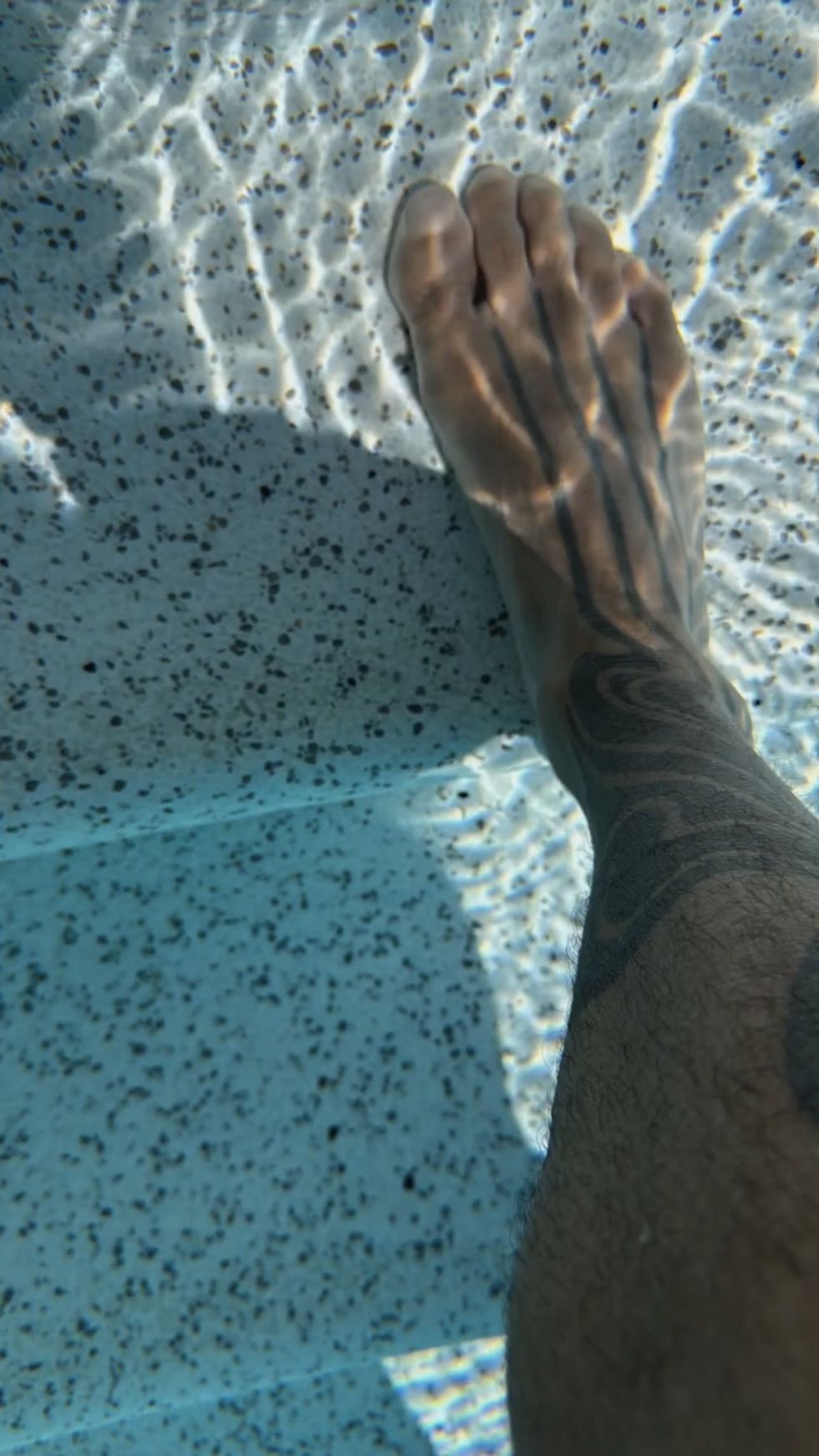 Ricky Martin's right foot in a swimming pool.