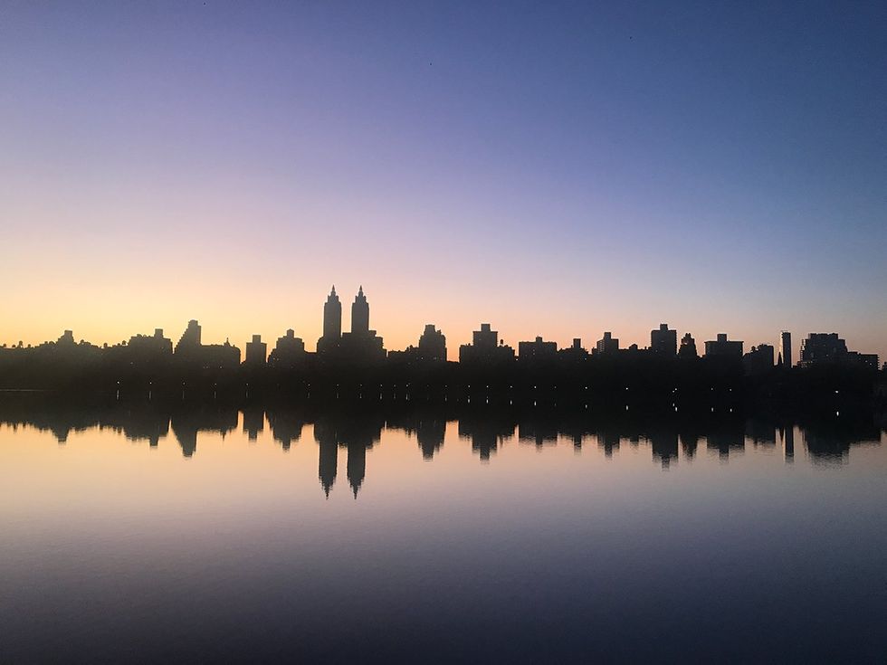 The sun sets over the Jacqueline Kennedy Onassis Reservoir in Central Park