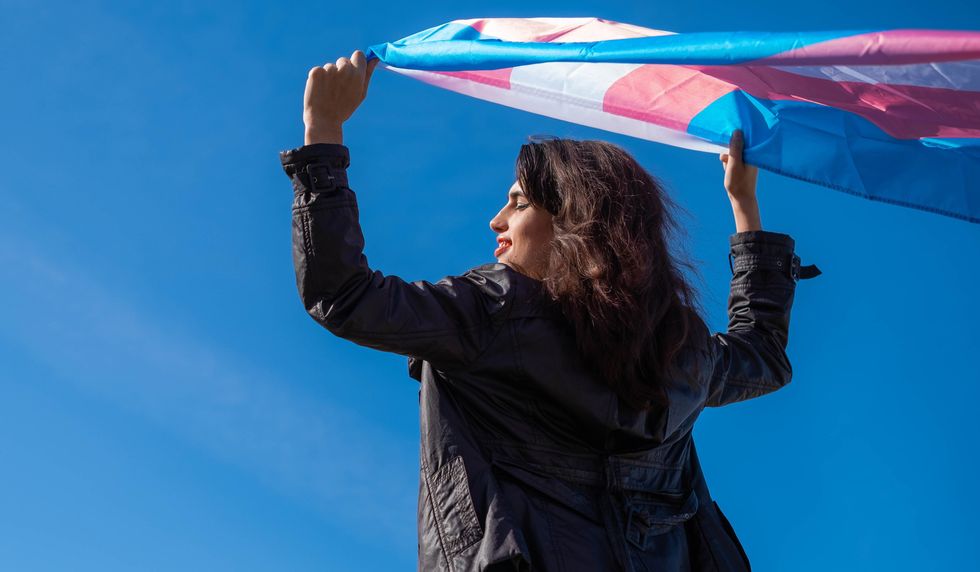 Transgender woman hold a trans flag