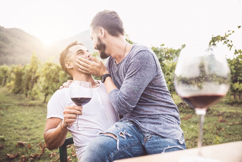 https://www.pride.com/media-library/two-men-drinking-wine-outdoors-and-sitting-together.jpg?id=33365810&width=784&quality=85