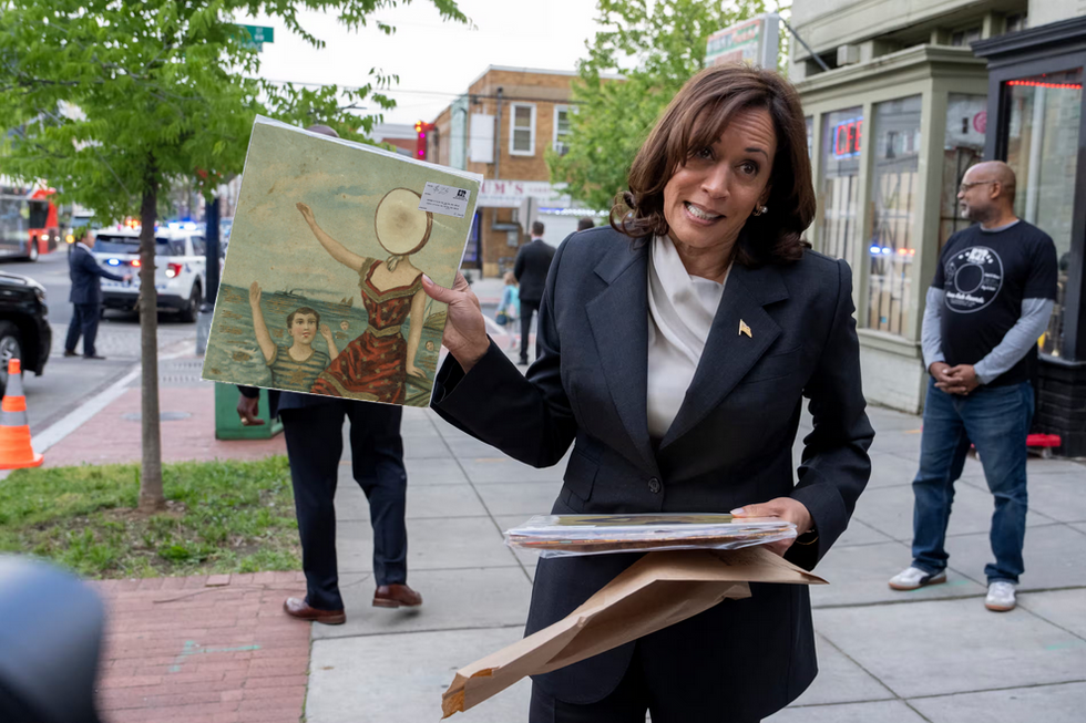 Vice President Kamala Harris holding a vinyl copy of "In the Aeroplane Over the Sea" by Nuetral Milk Hotel