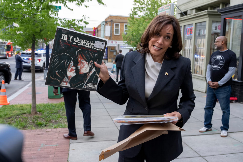 Vice President Kamala Harris holding a vinyl copy of the album "Three Cheers for Sweet Revenge" by M<y Chemical Romance