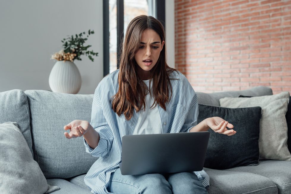 Woman with a laptop looking confused