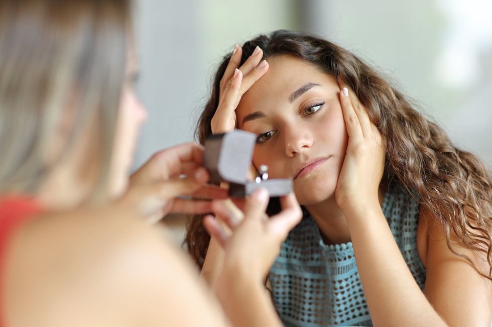 Worried lesbian woman in a marriage proposal rejecting engagement