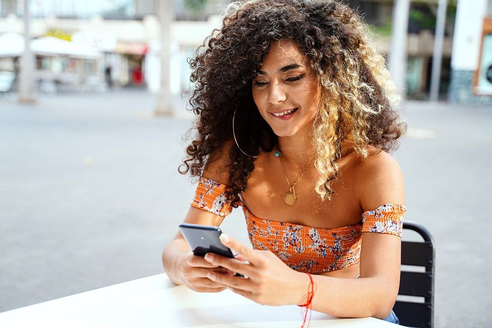 young latina woman on phone